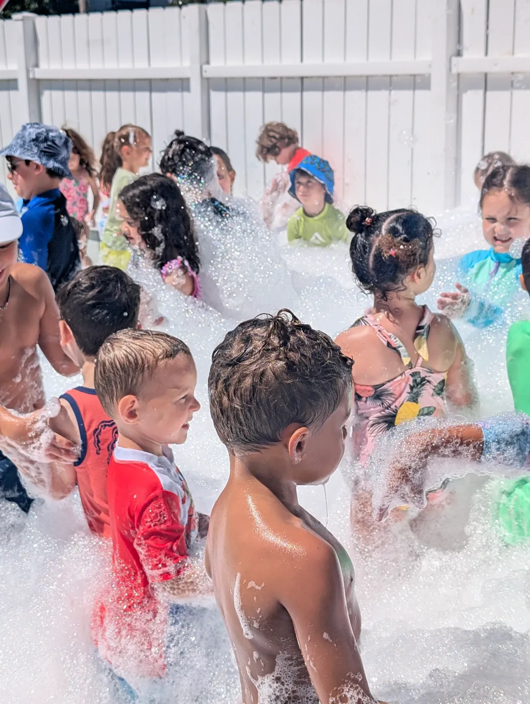 Children laughing together in foam